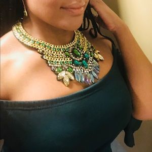 Costume necklace embellished primarily with green.